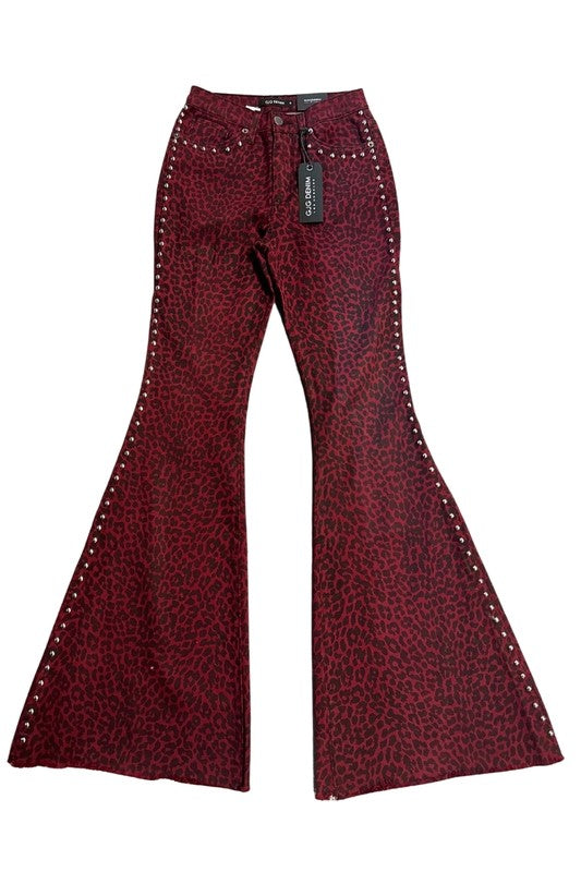 Leopard Studded Bell Bottom Pant in burgundy denim with a leopard print, featuring metallic stud detailing along the sides and a black tag attached.