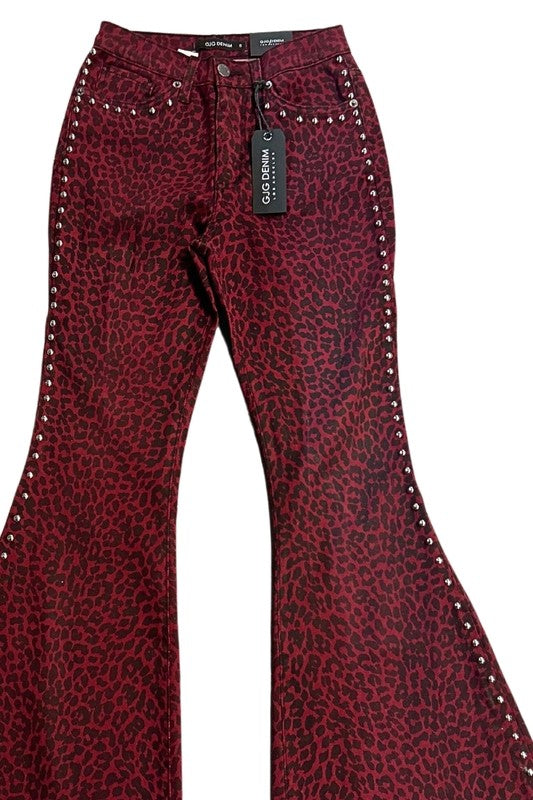 Leopard Studded Bell Bottom Pant in burgundy denim with a leopard print, featuring metallic stud detailing along the sides and a black tag attached.