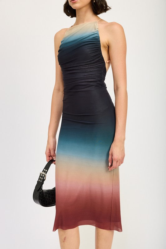 A woman wearing a small HALTER NECK OMBRE MAXI DRESS crafted from a blend of polyester and spandex stands against a plain background, pairing it perfectly with black sandals.