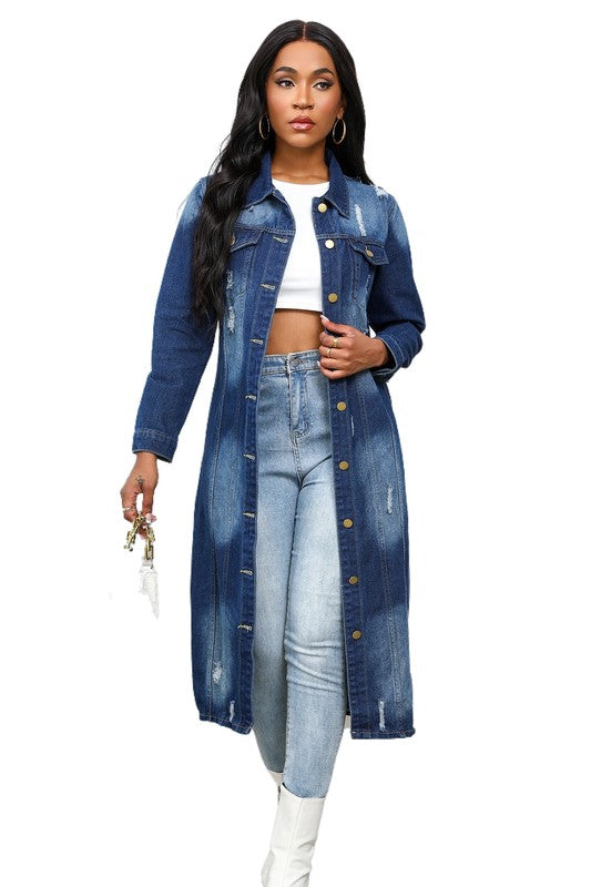 A person wearing the WOMEN MAXI LONG DENIM JACKET over a white crop top, light blue jeans, and white boots showcases a retro longline silhouette.