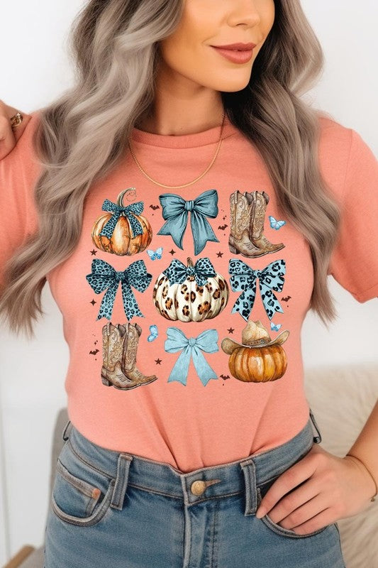 Person wearing a Turquoise Bow Western Fall Graphic Tee featuring illustrations of pumpkins, bows, cowboy hats, and boots adorned with blue and leopard print patterns. The high-quality printed design pairs perfectly with denim shorts and a denim jacket.