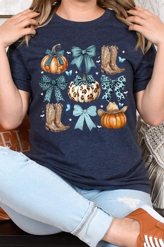 Person wearing a Turquoise Bow Western Fall Graphic Tee featuring illustrations of pumpkins, bows, cowboy hats, and boots adorned with blue and leopard print patterns. The high-quality printed design pairs perfectly with denim shorts and a denim jacket.