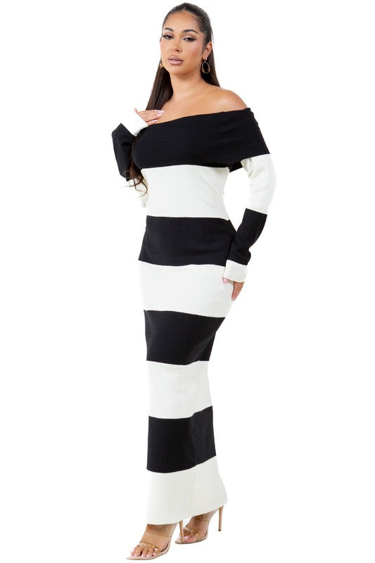 A woman wearing a WOMEN FASHION LONG MAXI KNIT DRESS, an off-the-shoulder, body-con maxi dress with black and white stripes, stands against a plain background.