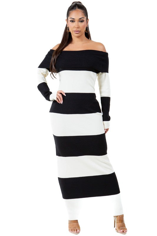 A woman wearing a WOMEN FASHION LONG MAXI KNIT DRESS, an off-the-shoulder, body-con maxi dress with black and white stripes, stands against a plain background.