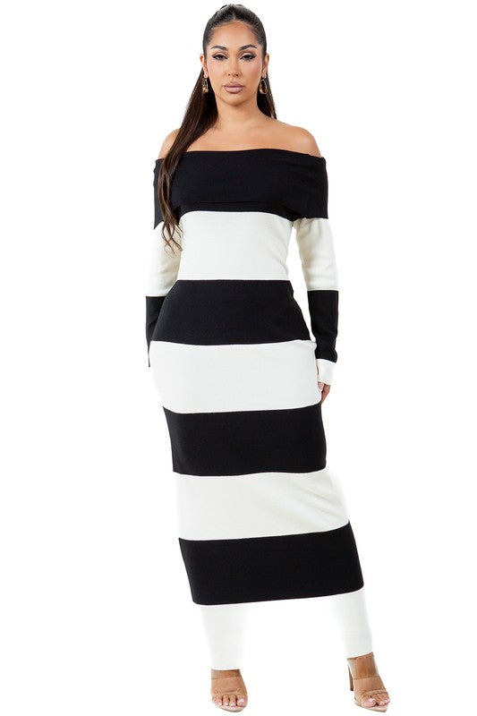 A woman wearing a WOMEN FASHION LONG MAXI KNIT DRESS, an off-the-shoulder, body-con maxi dress with black and white stripes, stands against a plain background.