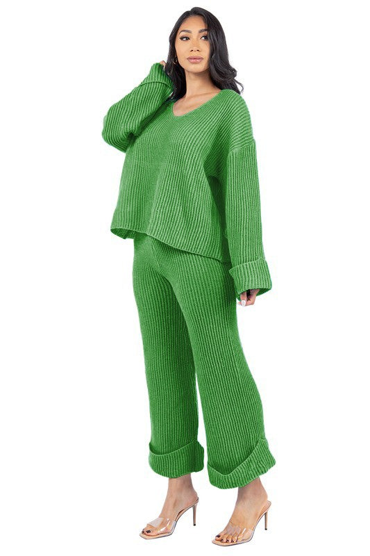 Person posing in the WOMEN FASHION 2PCS SWEATER PANTS SET, featuring a loose-fitting green knit top with bell sleeves and matching wide-leg pants.