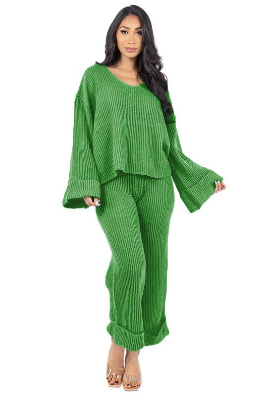 Person posing in the WOMEN FASHION 2PCS SWEATER PANTS SET, featuring a loose-fitting green knit top with bell sleeves and matching wide-leg pants.