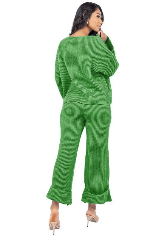 Person posing in the WOMEN FASHION 2PCS SWEATER PANTS SET, featuring a loose-fitting green knit top with bell sleeves and matching wide-leg pants.