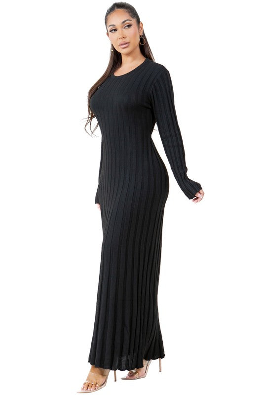 A woman is wearing a WOMEN FASHION KNITWEAR LONG MAXI DRESS, featuring long sleeves, a black ribbed texture, and a round neckline, standing against a plain background.