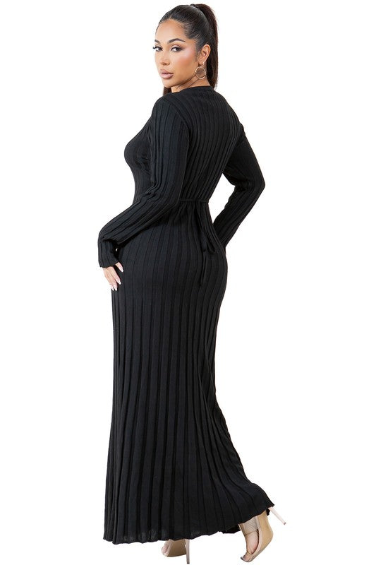 A woman is wearing a WOMEN FASHION KNITWEAR LONG MAXI DRESS, featuring long sleeves, a black ribbed texture, and a round neckline, standing against a plain background.