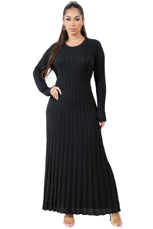 A woman is wearing a WOMEN FASHION KNITWEAR LONG MAXI DRESS, featuring long sleeves, a black ribbed texture, and a round neckline, standing against a plain background.