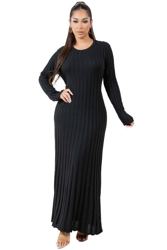 A woman is wearing a WOMEN FASHION KNITWEAR LONG MAXI DRESS, featuring long sleeves, a black ribbed texture, and a round neckline, standing against a plain background.