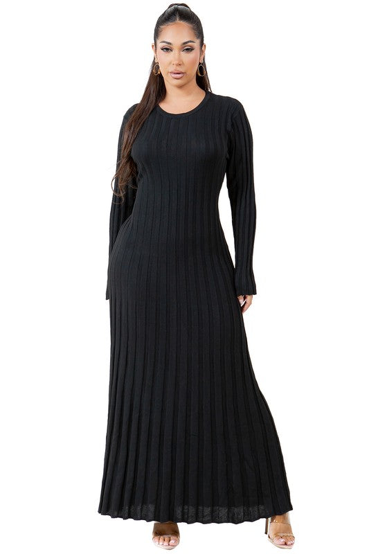 A woman is wearing a WOMEN FASHION KNITWEAR LONG MAXI DRESS, featuring long sleeves, a black ribbed texture, and a round neckline, standing against a plain background.