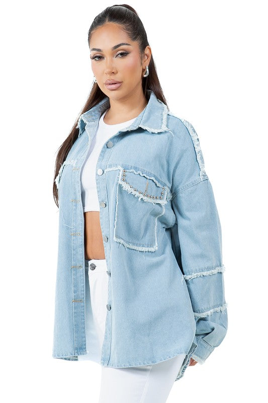 A woman wearing a beige oversize WOMEN FASHION OVERSIZE DENIM SHIRT with long sleeves, a white crop top, blue distressed denim shorts, large hoop earrings, and sunglasses.