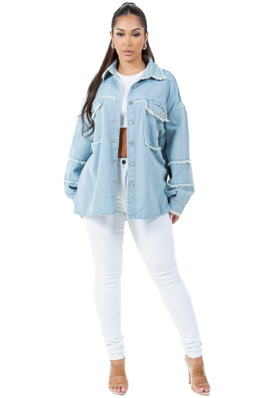 A woman wearing a beige oversize WOMEN FASHION OVERSIZE DENIM SHIRT with long sleeves, a white crop top, blue distressed denim shorts, large hoop earrings, and sunglasses.