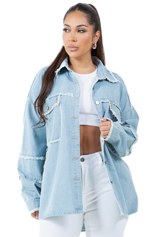 A woman wearing a beige oversize WOMEN FASHION OVERSIZE DENIM SHIRT with long sleeves, a white crop top, blue distressed denim shorts, large hoop earrings, and sunglasses.