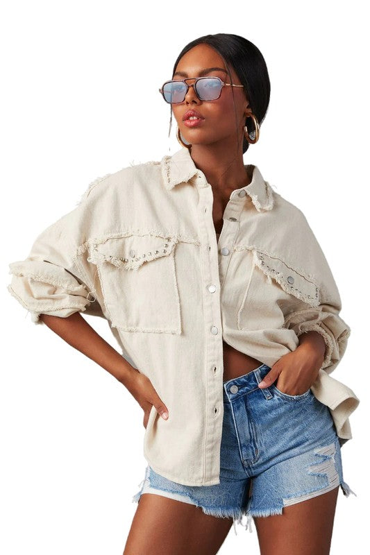 A woman wearing a beige oversize WOMEN FASHION OVERSIZE DENIM SHIRT with long sleeves, a white crop top, blue distressed denim shorts, large hoop earrings, and sunglasses.