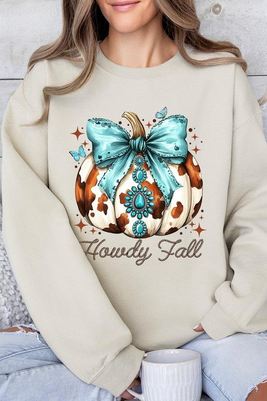 Person wearing a light gray sweatshirt with a decorative pumpkin design featuring a teal bow and the text "Howdy Fall." This stylish piece is part of our Howdy Fall Western Pumpkin Fleece Sweatshirts collection, perfect for anyone looking for unisex crew neck sweaters this season.