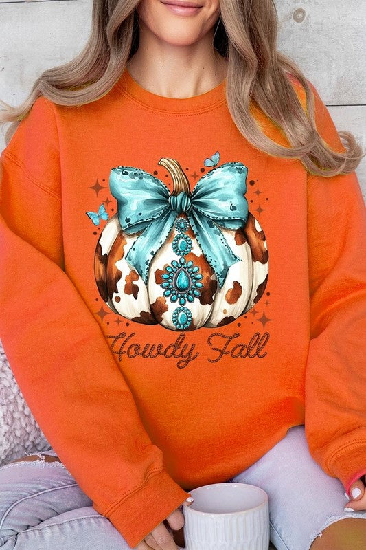 Person wearing a light gray sweatshirt with a decorative pumpkin design featuring a teal bow and the text "Howdy Fall." This stylish piece is part of our Howdy Fall Western Pumpkin Fleece Sweatshirts collection, perfect for anyone looking for unisex crew neck sweaters this season.