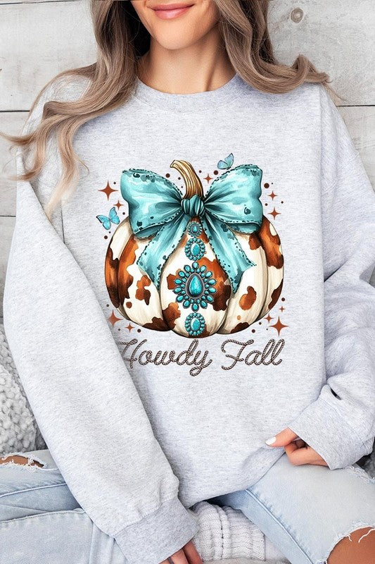 Person wearing a light gray sweatshirt with a decorative pumpkin design featuring a teal bow and the text "Howdy Fall." This stylish piece is part of our Howdy Fall Western Pumpkin Fleece Sweatshirts collection, perfect for anyone looking for unisex crew neck sweaters this season.