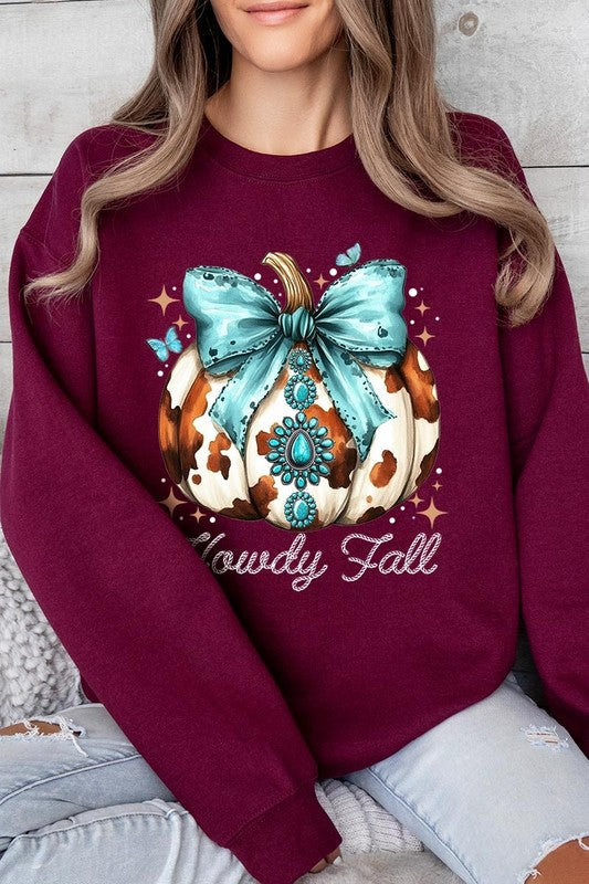 Person wearing a light gray sweatshirt with a decorative pumpkin design featuring a teal bow and the text "Howdy Fall." This stylish piece is part of our Howdy Fall Western Pumpkin Fleece Sweatshirts collection, perfect for anyone looking for unisex crew neck sweaters this season.