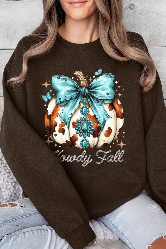 Person wearing a light gray sweatshirt with a decorative pumpkin design featuring a teal bow and the text "Howdy Fall." This stylish piece is part of our Howdy Fall Western Pumpkin Fleece Sweatshirts collection, perfect for anyone looking for unisex crew neck sweaters this season.