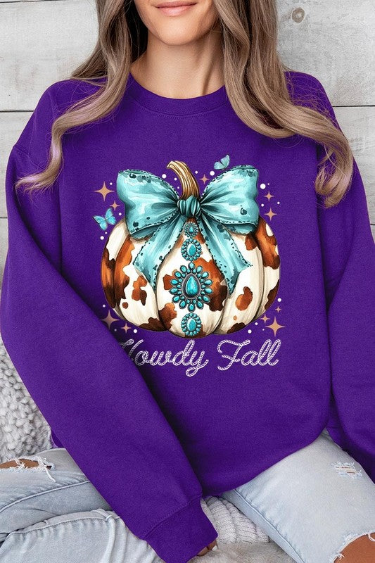 Person wearing a light gray sweatshirt with a decorative pumpkin design featuring a teal bow and the text "Howdy Fall." This stylish piece is part of our Howdy Fall Western Pumpkin Fleece Sweatshirts collection, perfect for anyone looking for unisex crew neck sweaters this season.