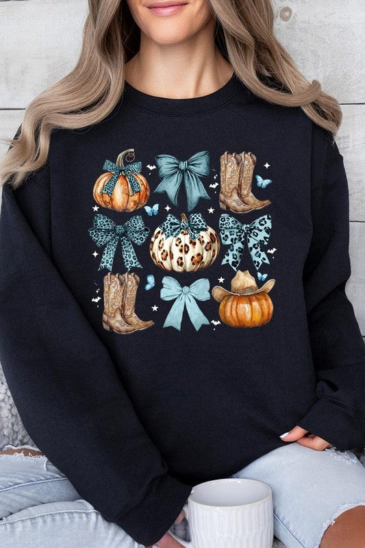 A woman is wearing a high-quality Turquoise Bow Western Fall Fleece Sweatshirt in olive green, featuring pumpkins, cowboy boots, a hat, and turquoise bows. She is seated on a gray, textured surface and wears light blue ripped jeans.