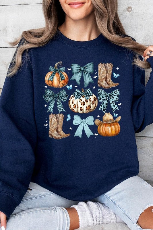 A woman is wearing a high-quality Turquoise Bow Western Fall Fleece Sweatshirt in olive green, featuring pumpkins, cowboy boots, a hat, and turquoise bows. She is seated on a gray, textured surface and wears light blue ripped jeans.