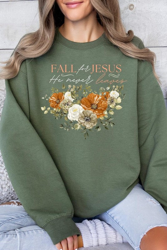 A person wearing a beige "Fall For Jesus He Never Leaves Fleece Sweatshirt" featuring a floral design and the text "FALL for JESUS He never leaves." This unisex crew neck fleece makes an excellent family group gift.