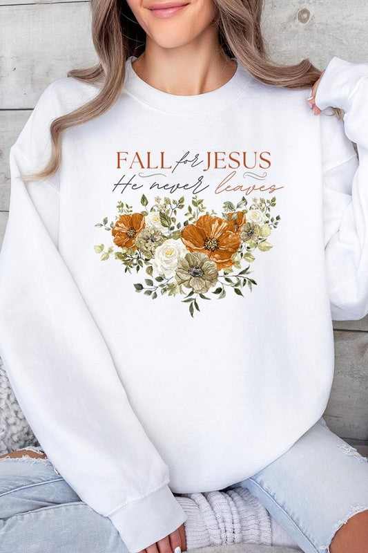 A person wearing a beige "Fall For Jesus He Never Leaves Fleece Sweatshirt" featuring a floral design and the text "FALL for JESUS He never leaves." This unisex crew neck fleece makes an excellent family group gift.