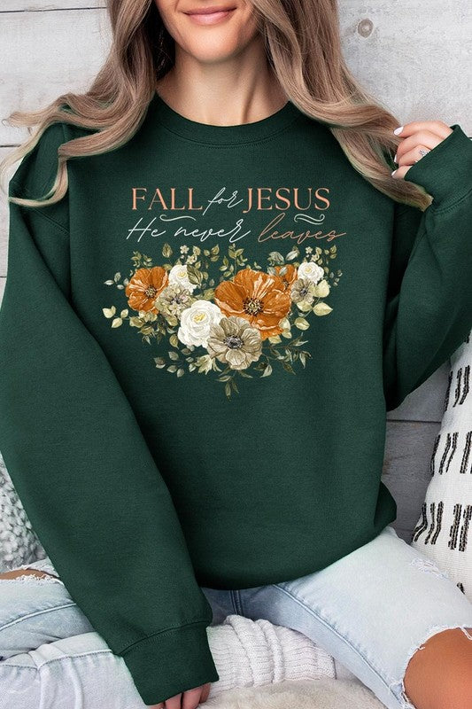 A person wearing a beige "Fall For Jesus He Never Leaves Fleece Sweatshirt" featuring a floral design and the text "FALL for JESUS He never leaves." This unisex crew neck fleece makes an excellent family group gift.