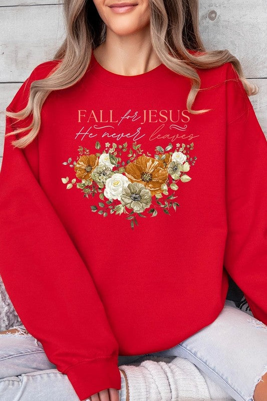 A person wearing a beige "Fall For Jesus He Never Leaves Fleece Sweatshirt" featuring a floral design and the text "FALL for JESUS He never leaves." This unisex crew neck fleece makes an excellent family group gift.