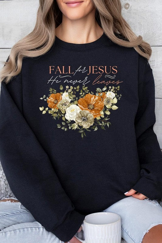 A person wearing a beige "Fall For Jesus He Never Leaves Fleece Sweatshirt" featuring a floral design and the text "FALL for JESUS He never leaves." This unisex crew neck fleece makes an excellent family group gift.