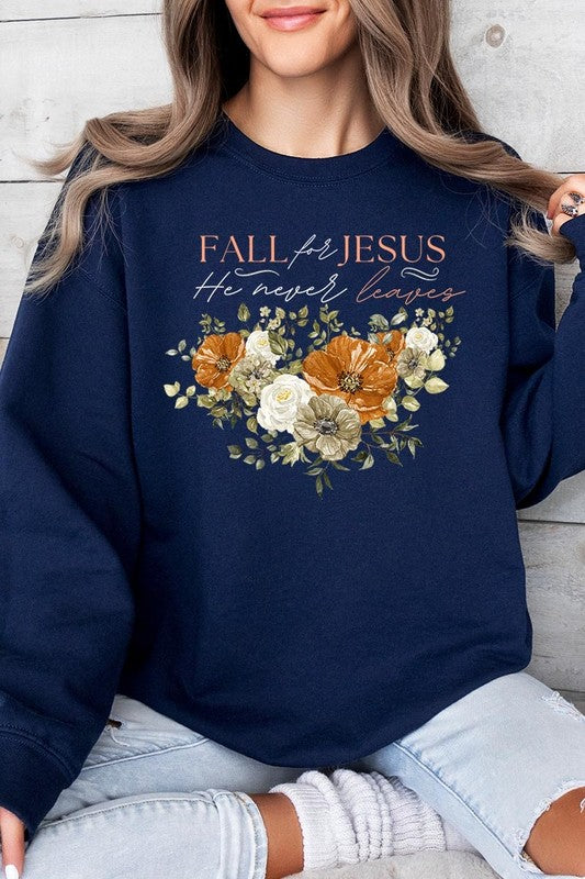 A person wearing a beige "Fall For Jesus He Never Leaves Fleece Sweatshirt" featuring a floral design and the text "FALL for JESUS He never leaves." This unisex crew neck fleece makes an excellent family group gift.