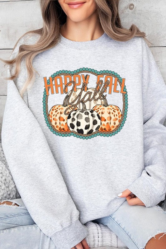 Woman wearing a green "Happy Fall Y'all" Graphic Fleece Sweatshirt featuring three patterned pumpkins printed on the front.