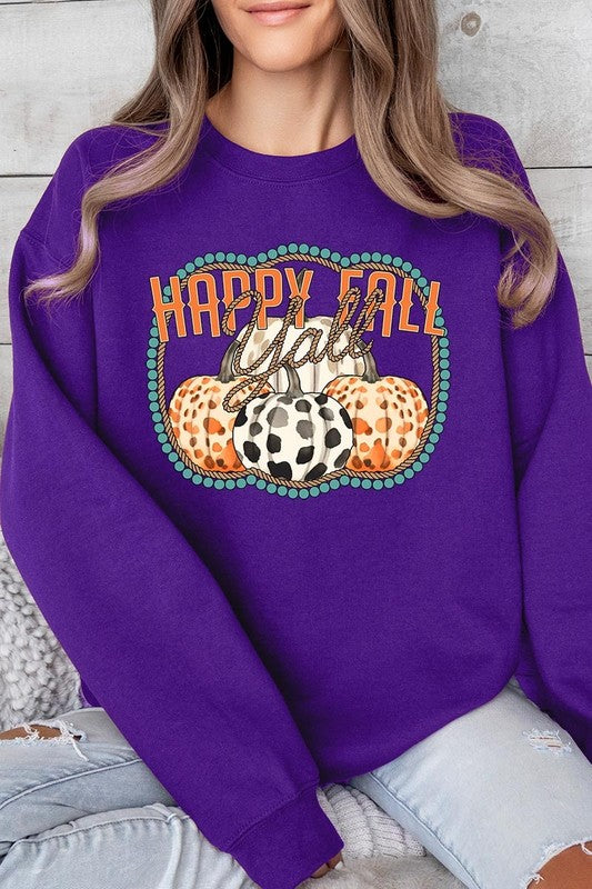 Woman wearing a green "Happy Fall Y'all" Graphic Fleece Sweatshirt featuring three patterned pumpkins printed on the front.