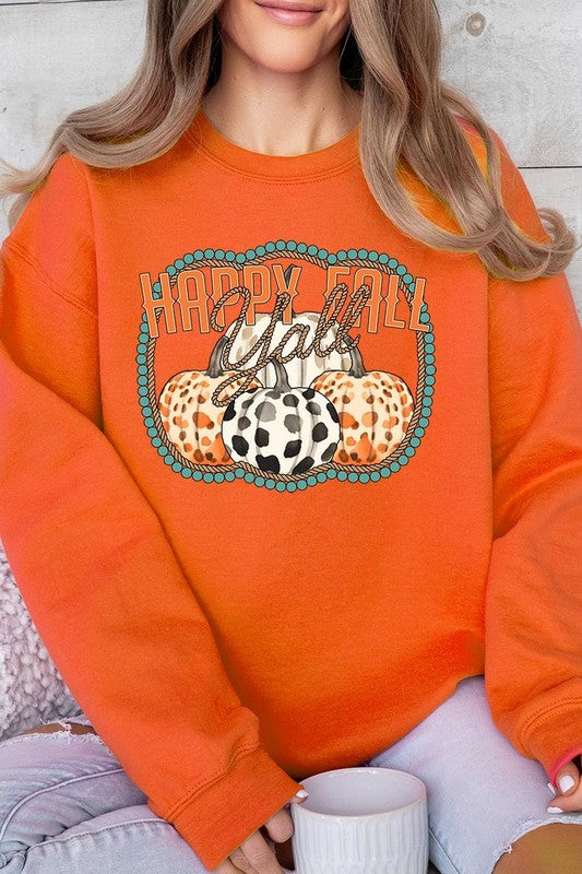 Woman wearing a green "Happy Fall Y'all" Graphic Fleece Sweatshirt featuring three patterned pumpkins printed on the front.