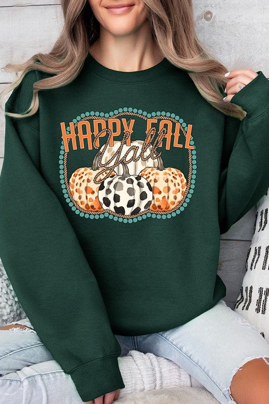 Woman wearing a green "Happy Fall Y'all" Graphic Fleece Sweatshirt featuring three patterned pumpkins printed on the front.