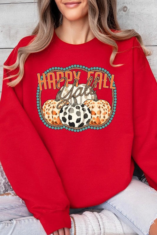 Woman wearing a green "Happy Fall Y'all" Graphic Fleece Sweatshirt featuring three patterned pumpkins printed on the front.