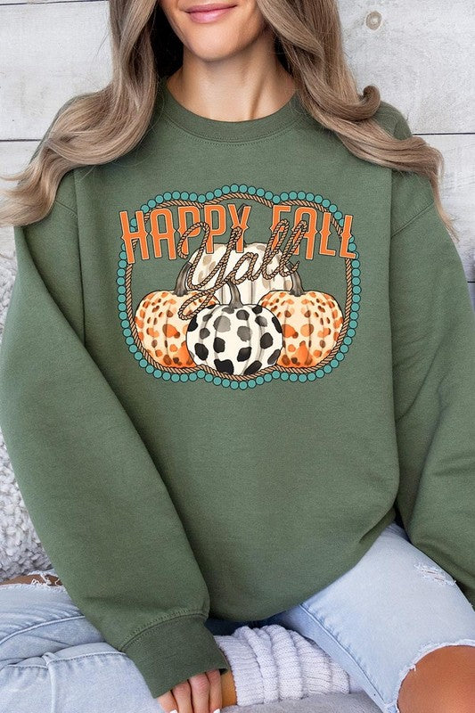 Woman wearing a green "Happy Fall Y'all" Graphic Fleece Sweatshirt featuring three patterned pumpkins printed on the front.