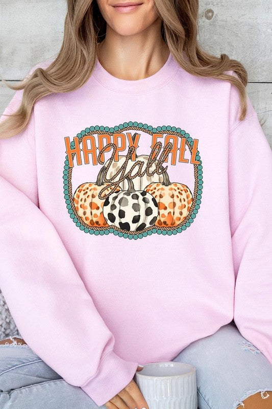 Woman wearing a green "Happy Fall Y'all" Graphic Fleece Sweatshirt featuring three patterned pumpkins printed on the front.