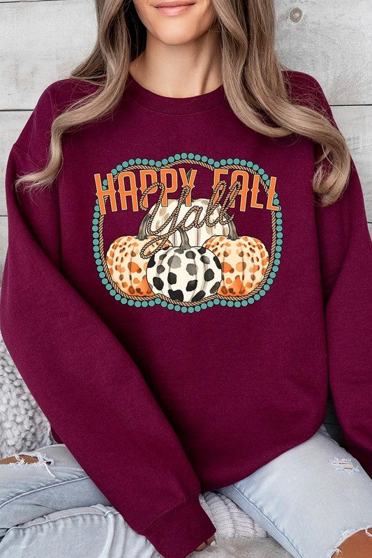 Woman wearing a green "Happy Fall Y'all" Graphic Fleece Sweatshirt featuring three patterned pumpkins printed on the front.