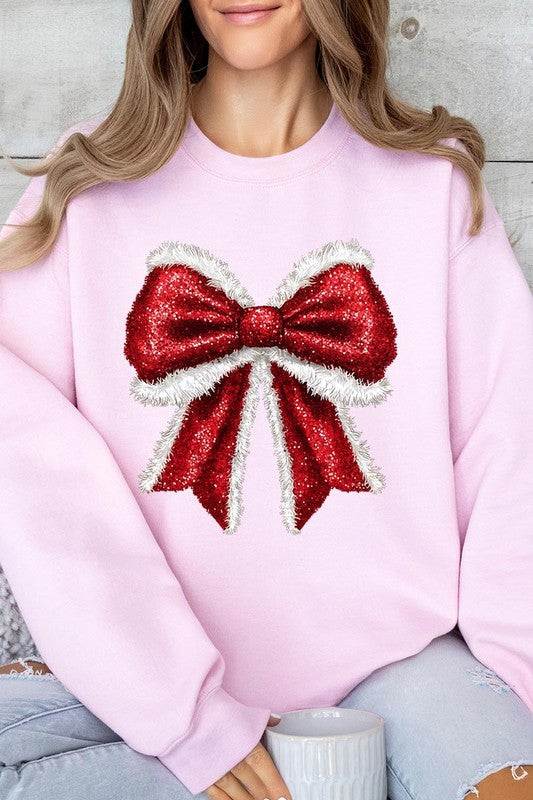 Person wearing a Christmas Santa Bow Graphic Fleece Sweatshirt in dark green, showcasing a large, glittery red and white Santa bow graphic on the front.