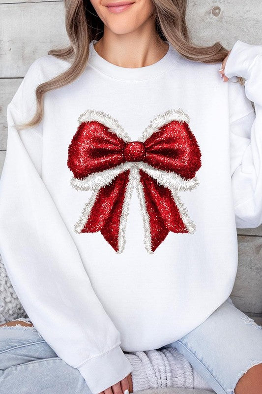 Person wearing a Christmas Santa Bow Graphic Fleece Sweatshirt in dark green, showcasing a large, glittery red and white Santa bow graphic on the front.