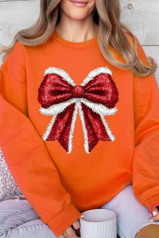 Person wearing a Christmas Santa Bow Graphic Fleece Sweatshirt in dark green, showcasing a large, glittery red and white Santa bow graphic on the front.