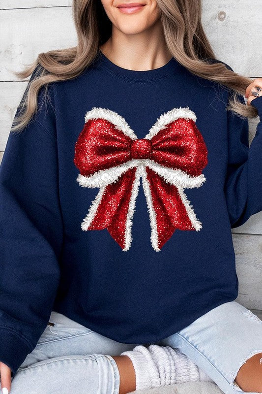 Person wearing a Christmas Santa Bow Graphic Fleece Sweatshirt in dark green, showcasing a large, glittery red and white Santa bow graphic on the front.