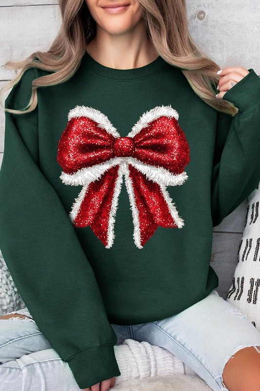 Person wearing a Christmas Santa Bow Graphic Fleece Sweatshirt in dark green, showcasing a large, glittery red and white Santa bow graphic on the front.