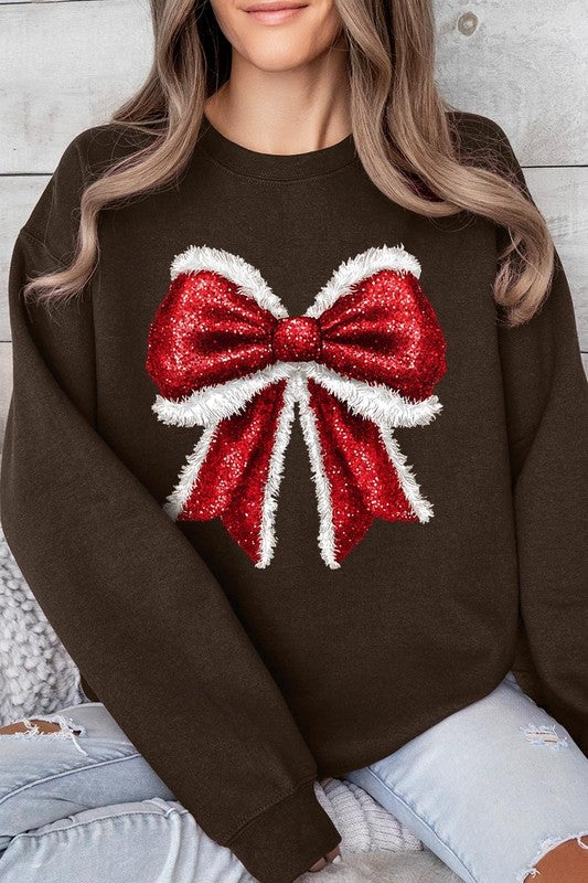 Person wearing a Christmas Santa Bow Graphic Fleece Sweatshirt in dark green, showcasing a large, glittery red and white Santa bow graphic on the front.