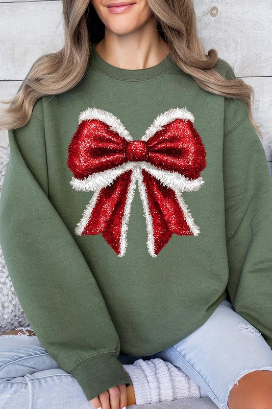 Person wearing a Christmas Santa Bow Graphic Fleece Sweatshirt in dark green, showcasing a large, glittery red and white Santa bow graphic on the front.